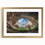 Elegant gold-framed landscape artwork depicting tranquil caves, complemented by a white mat, perfect for enhancing home decor with a touch of sophistication and nature-inspired beauty.
