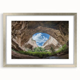 Framed landscape artwork showcasing a serene cave scene, elegantly matted and finished with a silver frame, perfect for enhancing modern home decor.