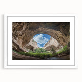 Framed landscape artwork depicting a serene cave scene with a white mat, ideal for enhancing home decor. Perfect for nature lovers and art enthusiasts.