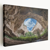 Stretched canvas artwork depicting a vibrant landscape scene with intricate cave formations and rich earthy tones, ideal for home decor or art collectors.
