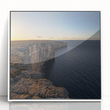 Framed acrylic artwork showcasing a breathtaking landscape of dramatic cliffs under a vibrant sky, featuring a sleek white frame that enhances its modern aesthetic. Perfect for adding a touch of nature-inspired elegance to any room's decor.