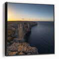 Framed canvas artwork depicting a scenic landscape of majestic cliffs in vibrant colors, showcasing a black frame from a side view, perfect for home decor.