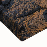 Close-up of a stretched canvas print depicting vibrant landscapes with dramatic cliffs and rich colors, ideal for enhancing home decor and art collections.