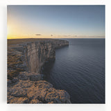 Stretched canvas artwork depicting a stunning landscape of rugged cliffs against a serene sky, showcasing vibrant colors and intricate details, perfect for home decor.