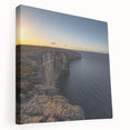 Stretched canvas print showcasing a breathtaking landscape of rugged cliffs against a vibrant blue sky, ideal for nature lovers and home decor enthusiasts. The artwork captures the serene beauty of natural formations, enhancing any space with its captivating colors and detailed textures.