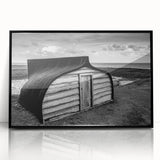 Framed acrylic wall art depicting a serene landscape with a rustic barn, featuring a black frame. Ideal for home decor, adding charm to any room.