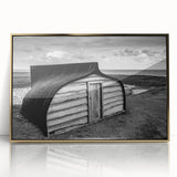 Framed acrylic wall art depicting a serene landscape with a rustic barn, featuring golden accents and a polished finish, perfect for home decor.