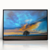 Framed acrylic artwork showcasing a serene landscape with lush green fields and a clear blue sky, elegantly presented in a sleek black frame, perfect for home decor.