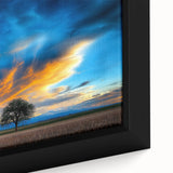 Framed canvas depicting a vibrant landscape with lush green fields and a bright blue sky, showcasing intricate details and rich colors that enhance any decor.