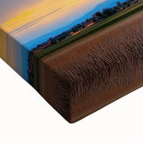 Close-up of a stretched canvas artwork depicting vibrant green fields under a blue sky, showcasing rich textures and intricate details, perfect for home decor.