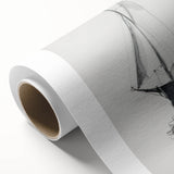 Rolled canvas showcasing a vibrant landscape design with rich colors and intricate details, elegantly packaged in a protective cardboard tube for safe delivery.