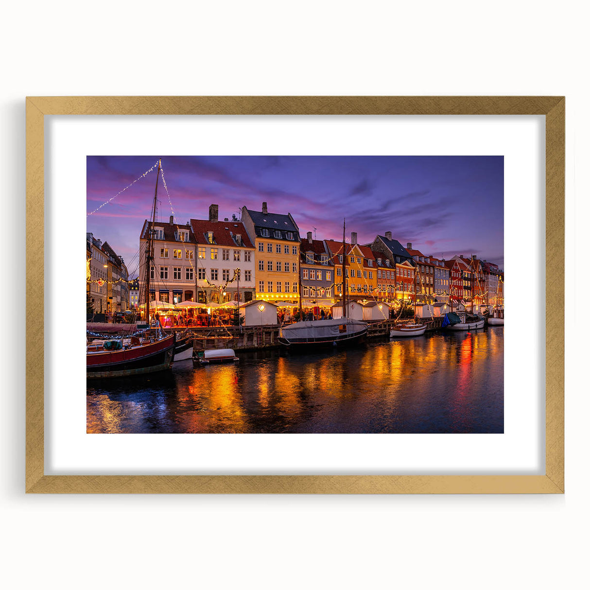 Abstract art print of a European landscape in muted gold and green tones, framed with a golden mat.