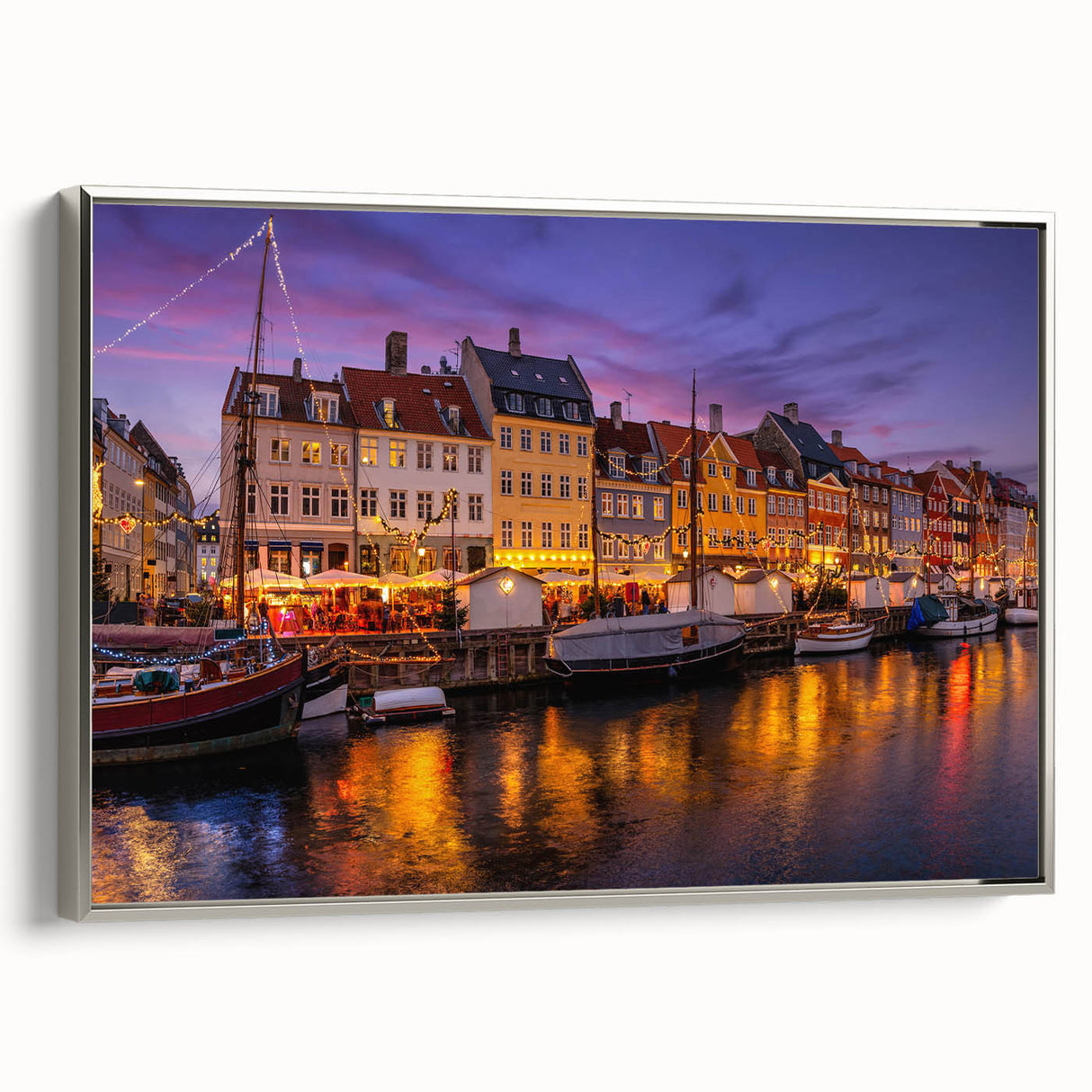 Framed canvas featuring a vintage-style landscape painting of a European countryside.