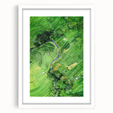 Abstract art print featuring swirling shades of blue and green, framed in white, suitable for bedroom or dining room decor.