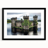 Framed landscape artwork showcasing a picturesque castle scene, featuring a black frame and matting that highlights the vibrant colors of the landscape, ideal for home decor.