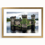 Elegant gold-framed landscape artwork showcasing a picturesque castle scene, complete with a decorative mat, perfect for enhancing home decor with classic charm.