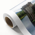 Rolled canvas showcasing a vibrant landscape of a medieval castle surrounded by lush greenery and a clear blue sky, designed for decorative wall art.