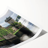 Rolled print showcasing a vibrant landscape with a majestic castle surrounded by lush greenery, elegantly packaged in a protective tube for delivery.