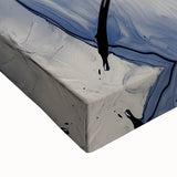 Colorful abstract splatter design on stretched canvas showcasing vibrant hues of blue, yellow, and red, perfect for modern home decor or art enthusiasts.