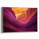 Framed canvas artwork depicting a stunning landscape of colorful canyons, showcased from a side view with a sleek silver frame, ideal for modern home decor.