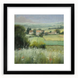 Framed landscape wall art depicting a serene countryside scene with vibrant green fields and a blue sky, featuring a sleek black frame and white mat.