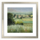 Framed landscape wall art showcasing a serene countryside scene with vibrant green fields and a blue sky, accented by a silver mat and frame. Ideal for home decor.
