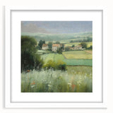 Framed landscape wall art depicting a serene countryside scene, featuring vibrant green fields and a clear blue sky, elegantly presented with a white mat.