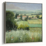 Framed landscape wall art depicting a serene countryside scene with vibrant green fields and a clear blue sky, showcased in a sleek silver frame. Ideal for home decor.