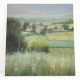 Stretched canvas wall art depicting a serene countryside landscape, featuring lush green fields and a vibrant sunset, designed to add warmth and tranquility to home decor.