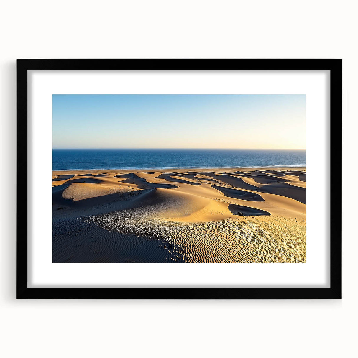 Framed landscape artwork depicting serene sand dunes, featuring a sleek black frame with a mat, perfect for modern home decor. Ideal for nature lovers and minimalistic interiors.