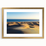 Framed landscape artwork showcasing serene sand dunes in warm gold tones, elegantly matted for display, perfect for home decor and interior design enhancement.
