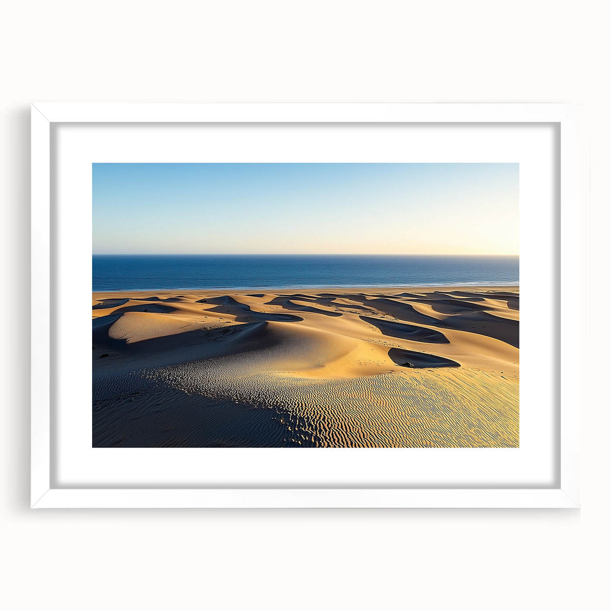 Framed landscape artwork of serene sand dunes, featuring a white mat and sleek frame, ideal for modern home decor. Perfect for nature-themed interiors.