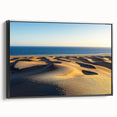 Framed canvas artwork showcasing a serene landscape of rolling dunes in earthy tones, displayed from a black side view, perfect for modern home decor.
