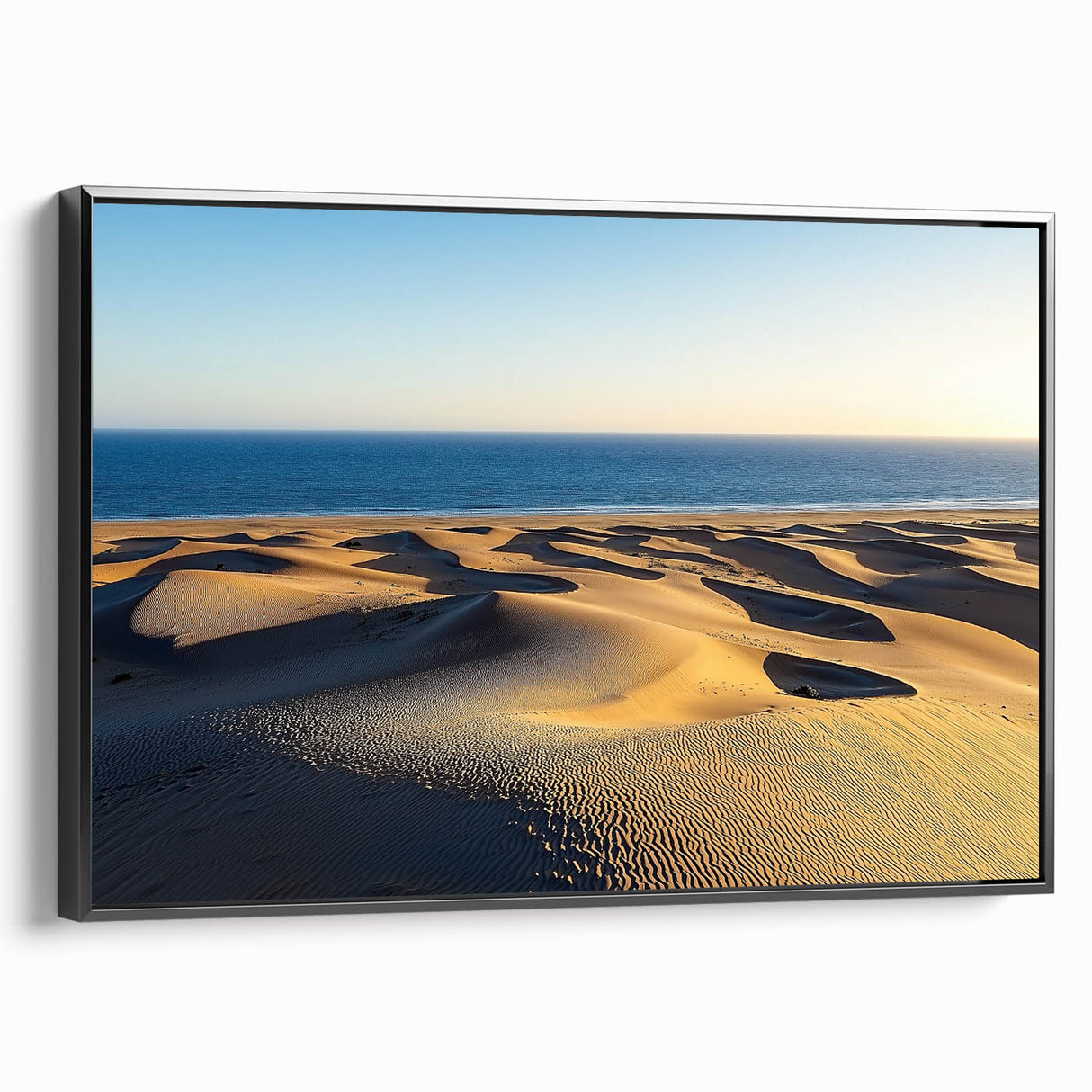 Framed canvas artwork showcasing a serene landscape of rolling dunes in earthy tones, displayed from a black side view, perfect for modern home decor.