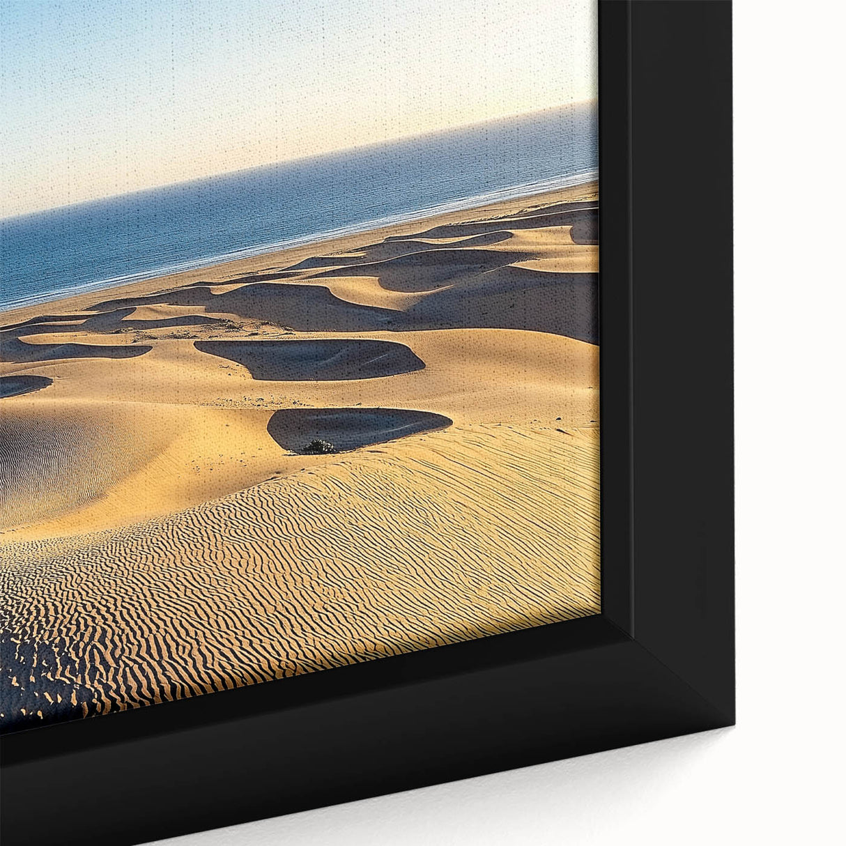 Close-up of a framed canvas artwork depicting serene sand dunes at sunset, showcasing warm golden and beige tones, perfect for enhancing modern home decor.