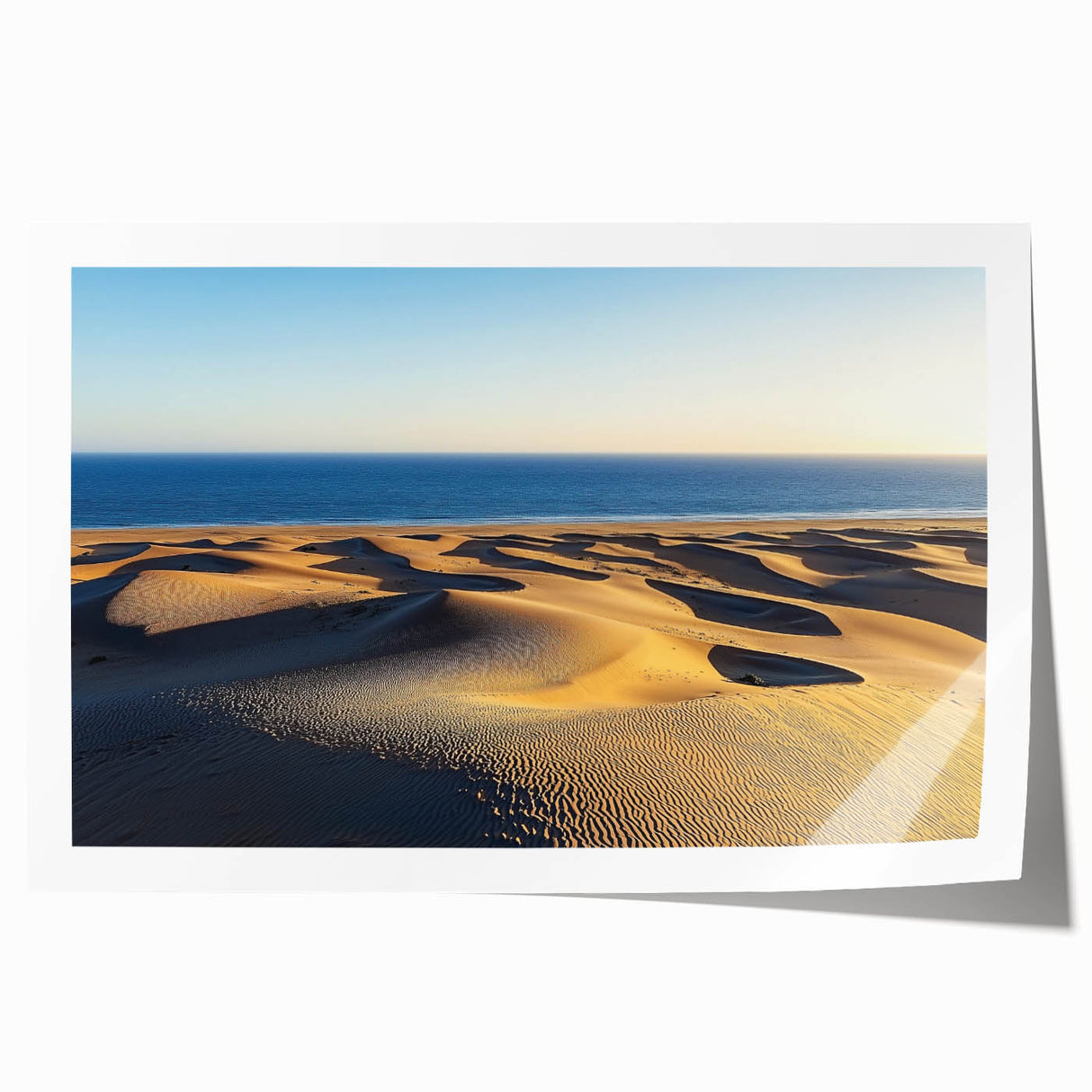 Desert landscape art print featuring rolling sand dunes in warm tones, elegantly rolled for display, ideal for home decor or art enthusiasts.