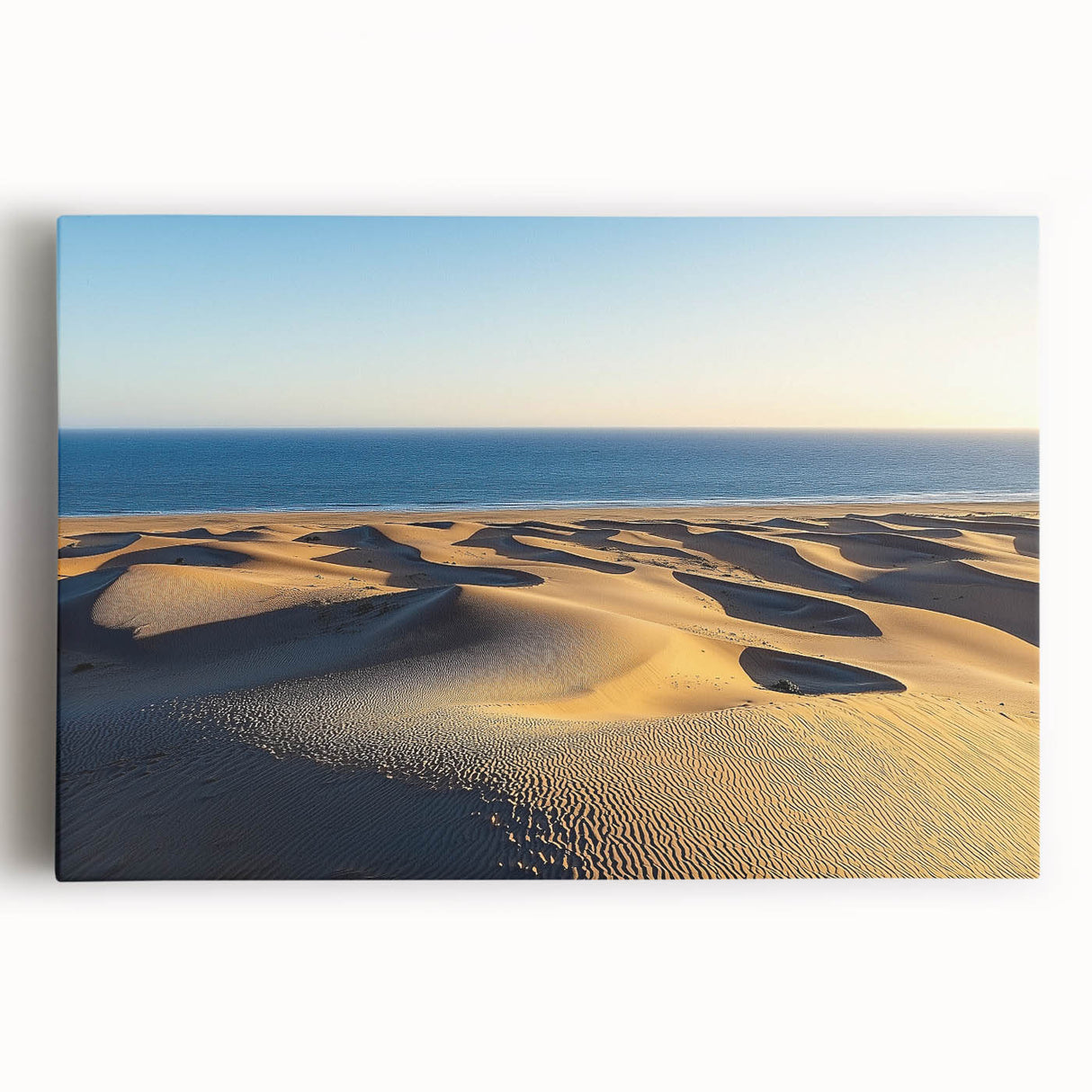 Stretched canvas artwork showcasing serene sand dunes at sunset, with warm hues of orange and gold, perfect for enhancing contemporary home decor.
