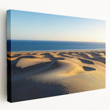 Stretched canvas artwork depicting serene desert dunes at sunset, showcasing warm golden and orange hues, perfect for enhancing modern home decor or art collections.