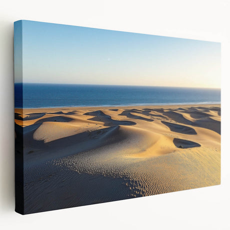 Stretched canvas artwork depicting serene desert dunes at sunset, showcasing warm golden and orange hues, perfect for enhancing modern home decor or art collections.