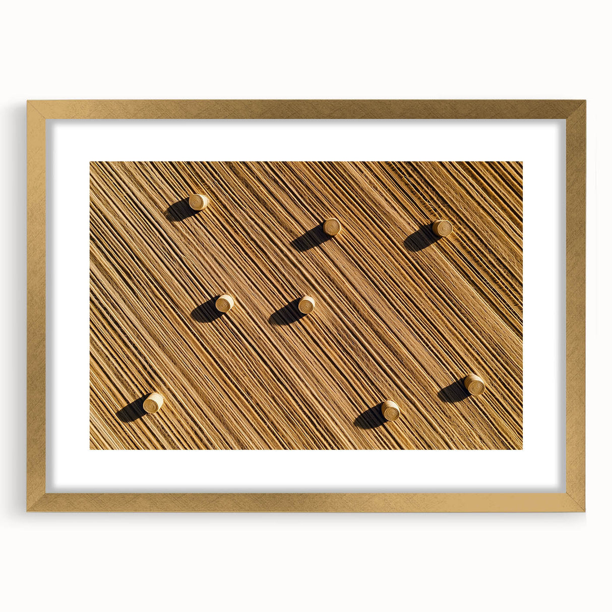 Framed landscape artwork showcasing vibrant fields in gold and green hues, elegantly bordered with a mat, ideal for home decor or office settings.