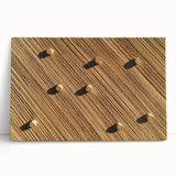 Stretched canvas artwork depicting vibrant green fields under a bright blue sky, leaning against a rustic wall, perfect for nature-inspired home decor.