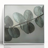 Close-up of green leaves, framed in white acrylic, reflecting a modern art deco style, suitable for nursery wall art.