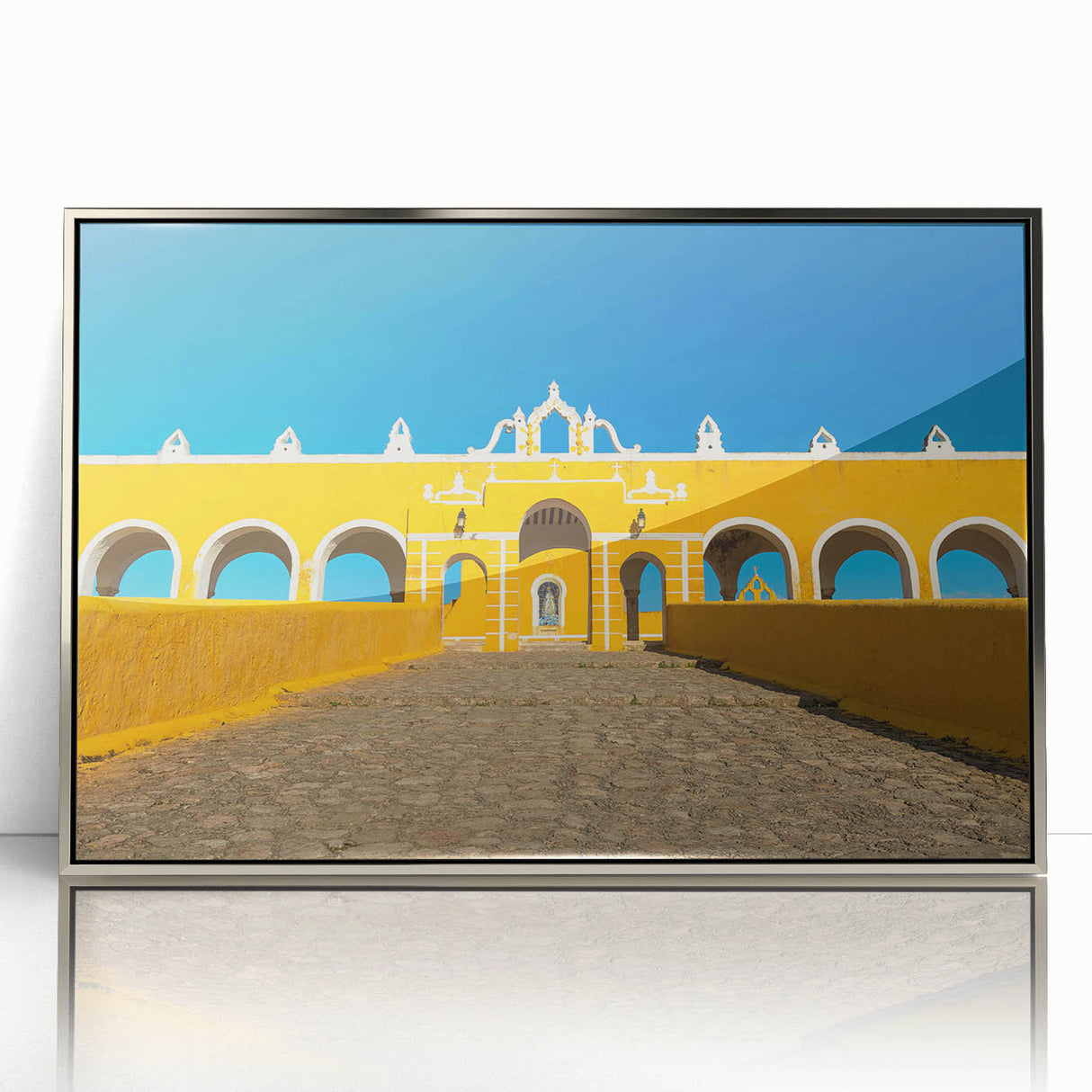 Mid-century modernist art depicting a Yucatan scenery in muted earth tones on a silver-framed acrylic.