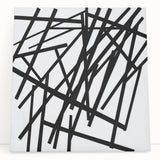 Abstract minimalist stretched canvas artwork featuring soft pastel colors and geometric shapes, leaning against a modern white wall, perfect for contemporary home decor.