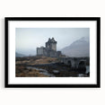 Elegant black-framed landscape artwork depicting a majestic castle surrounded by lush greenery, perfect for home decor or office enhancement. The frame features a classic design that complements the scenic view, creating a striking focal point.