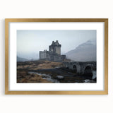 Elegant gold-framed landscape artwork showcasing a picturesque castle scene, accented with a white mat, perfect for home decor or gallery displays.