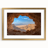 Framed landscape artwork featuring a cave scene with a gold mat, showcasing intricate details and vibrant colors, ideal for home decor and art enthusiasts.