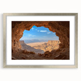 Framed landscape artwork depicting a serene cave scene, featuring a silver mat and elegant frame, ideal for enhancing home decor with natural beauty.
