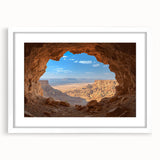 Framed landscape artwork featuring a serene cave scene with intricate detailing, set against a white mat. Ideal for nature lovers and home decor enthusiasts.
