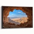 Framed canvas artwork showcasing a stunning landscape with caves, featuring rich colors and intricate details, set against a sleek black frame for modern decor.